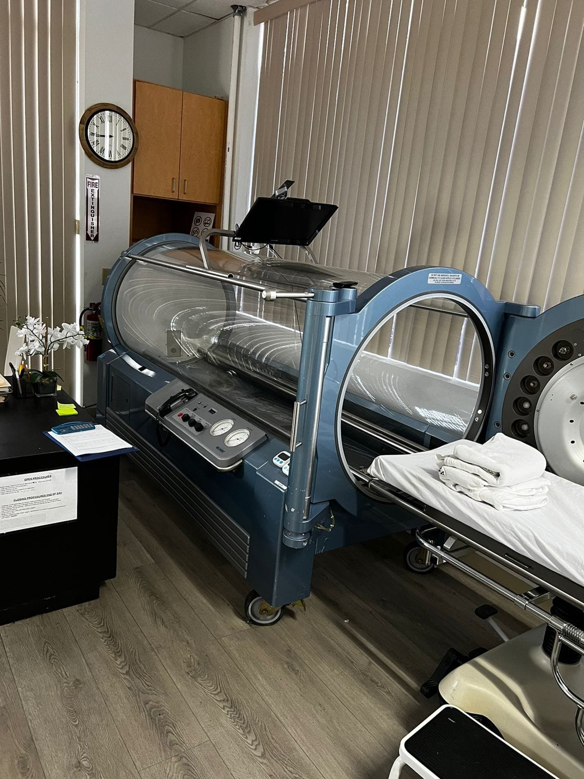 Medical-grade blue hyperbaric chamber in a treatment room at Pacific Hyperbarics — Oceanside